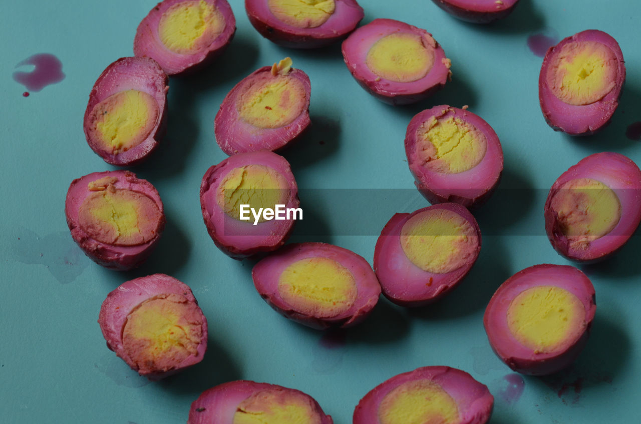 High angle view of pickled eggs on turquoise table