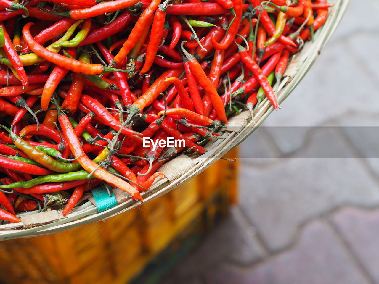 Close-up of red chili peppers in basket for sale