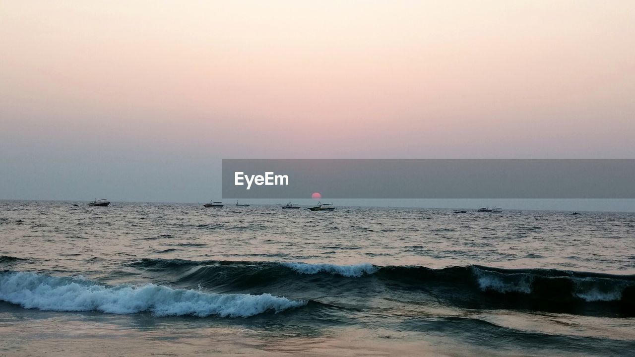 Scenic view of sea against sky at sunset