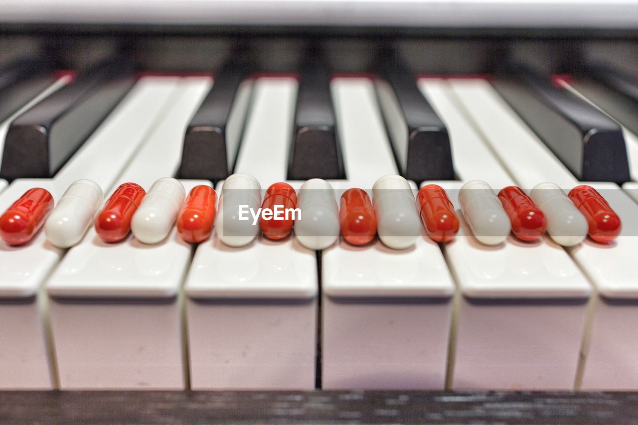 Close-up of capsules side by side on piano keys