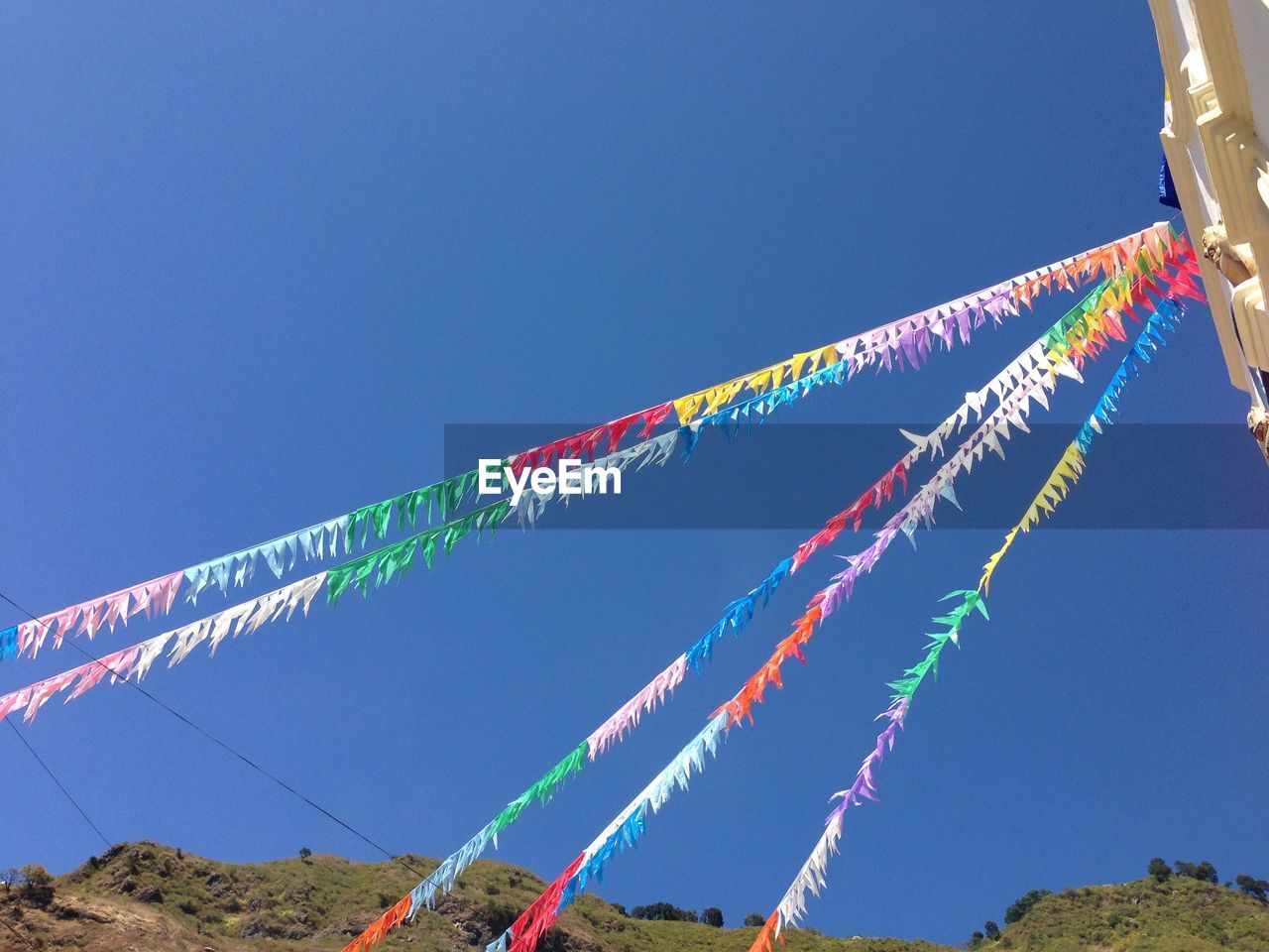 Prayer flags against clear blue sky