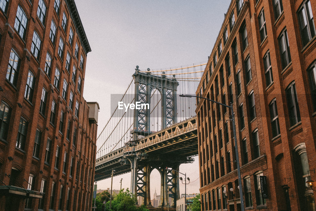 Low angle view of suspension bridge in city