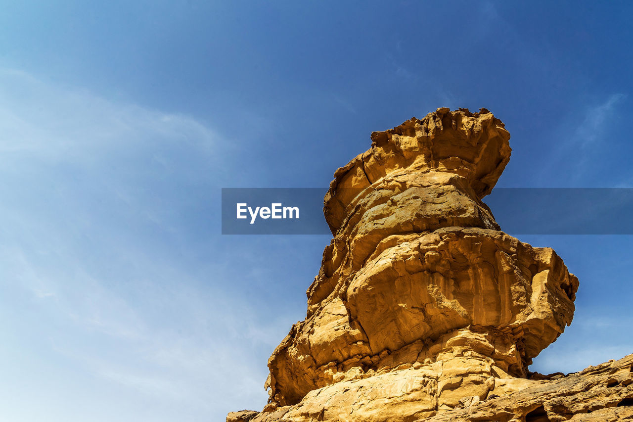 Impressive solitary rock with eolian erosion marks in the desert of wadi rum, jordan