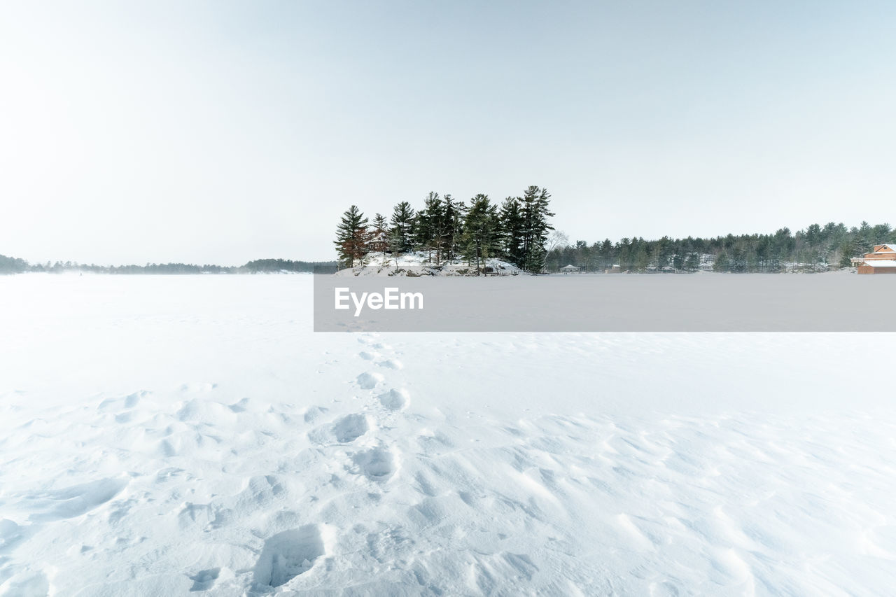 Scenic view of snow covered field against clear sky