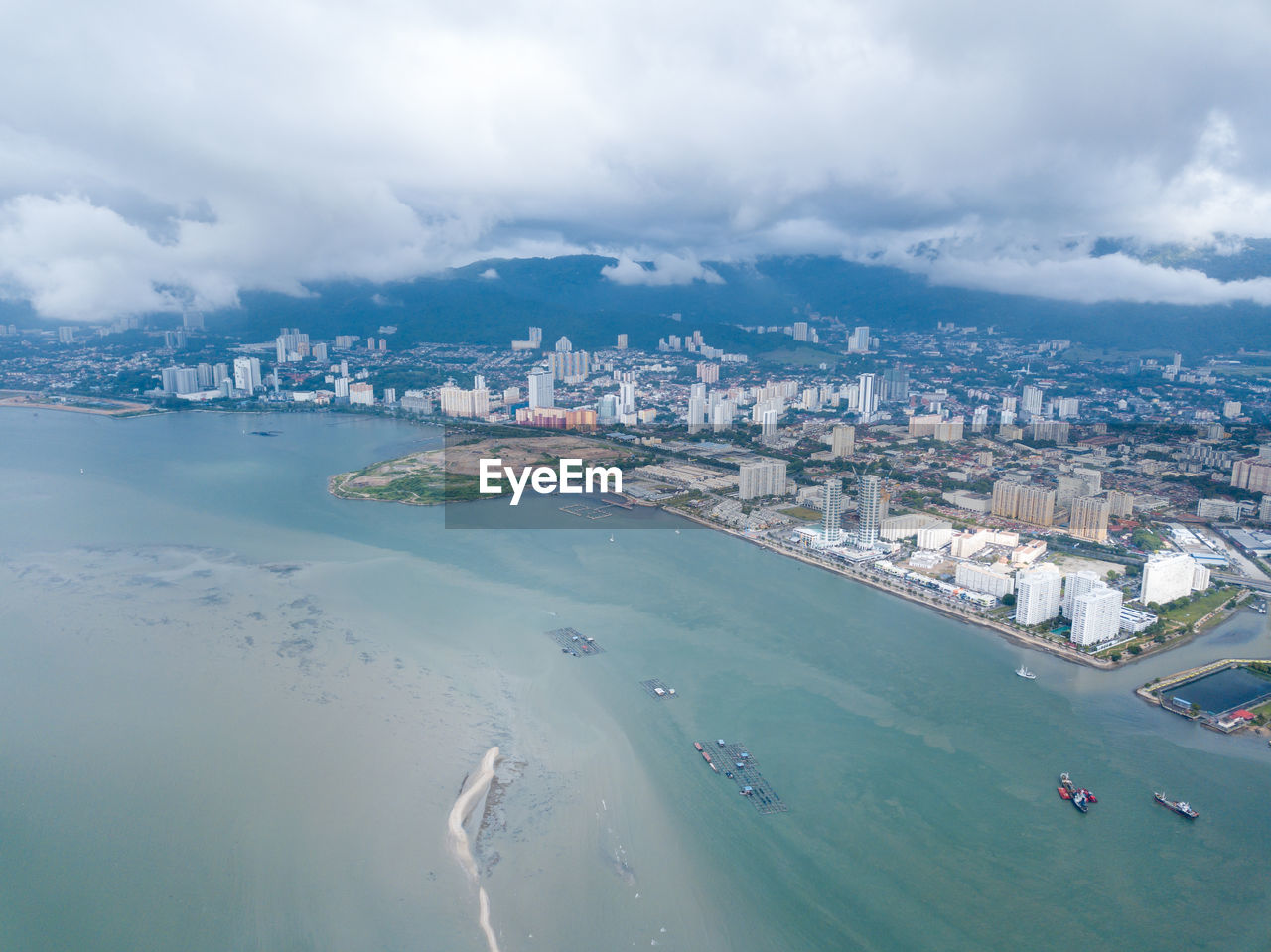 High angle view of buildings against cloudy sky