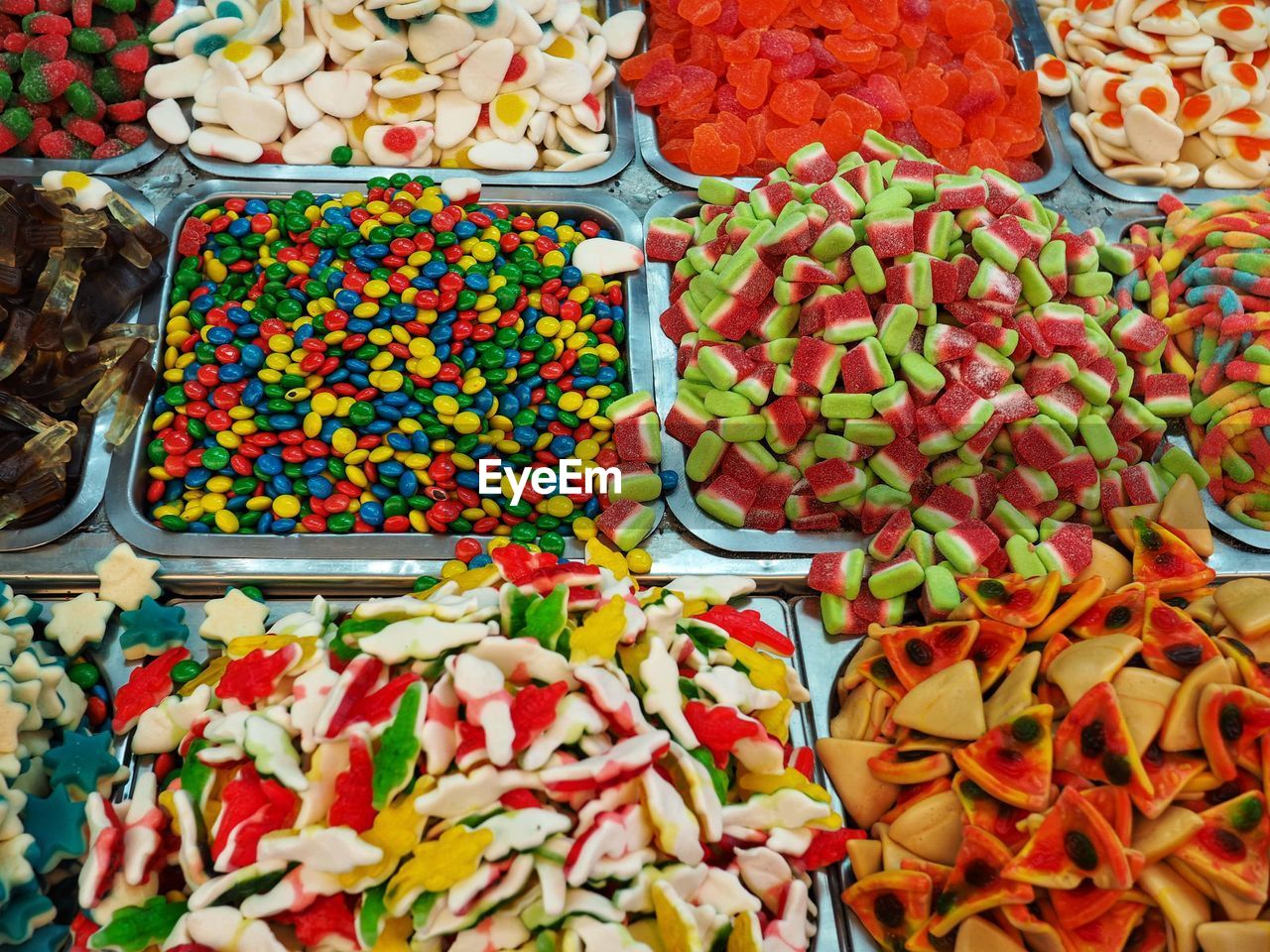 HIGH ANGLE VIEW OF MULTI COLORED CANDIES IN MARKET STALL