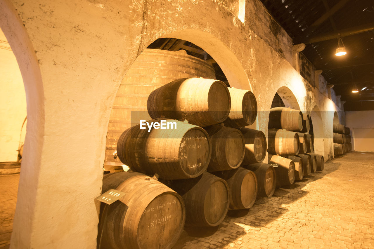 Barrels arranged at illuminated winery