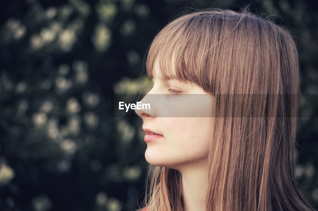 Close-up of teenage girl looking away
