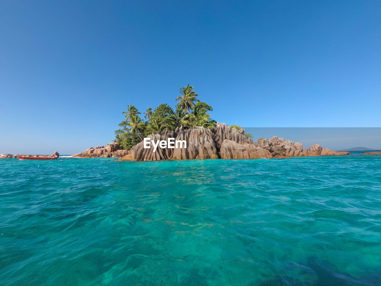 Scenic view of sea against clear blue sky