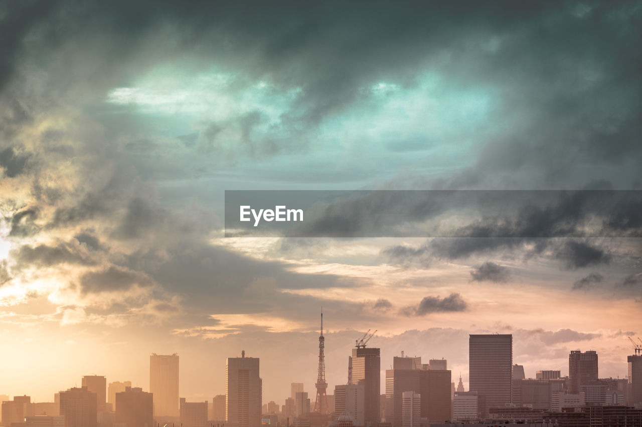 Modern buildings in city against sky during sunset in tokyo japan.