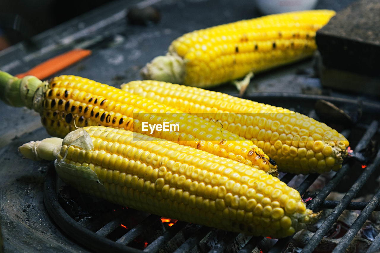 Close-up of corns on barbeque at street market