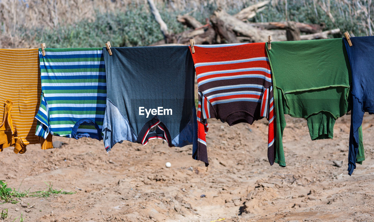 HOODED CHAIRS ON BEACH UMBRELLA ON FIELD