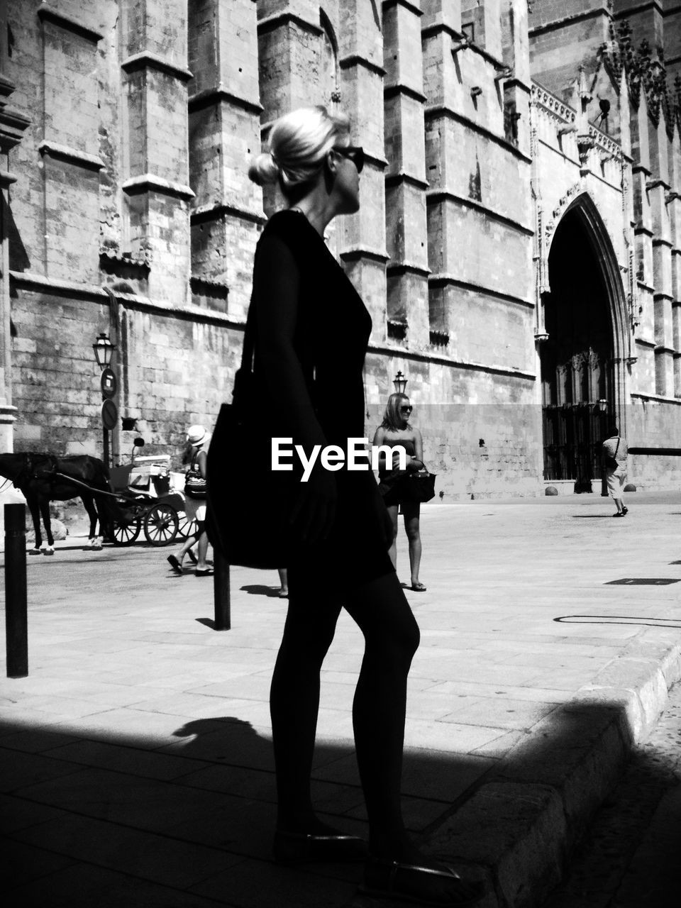 LOW ANGLE VIEW OF WOMAN STANDING ON STEPS