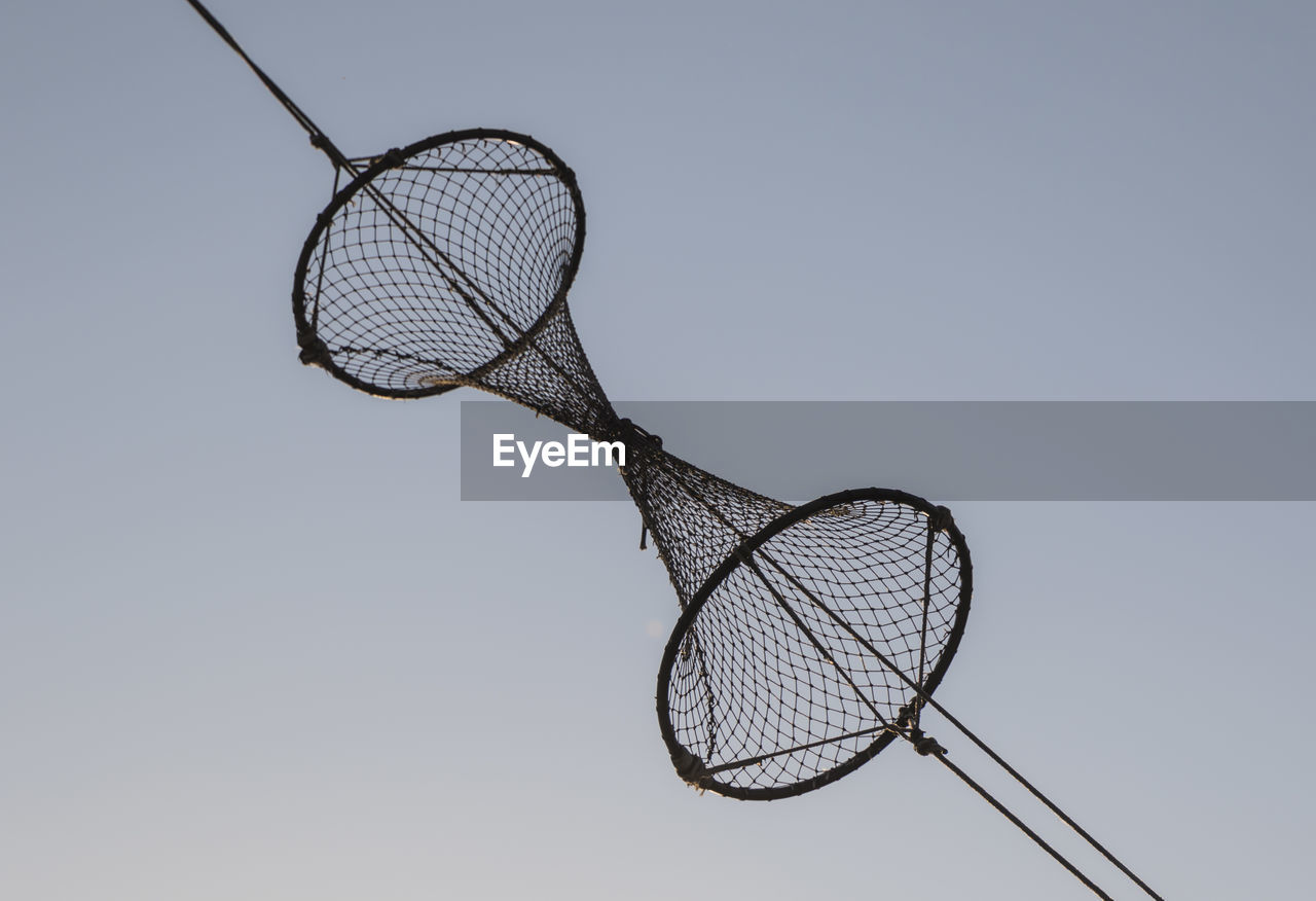 Close-up of nets hanging against clear sky