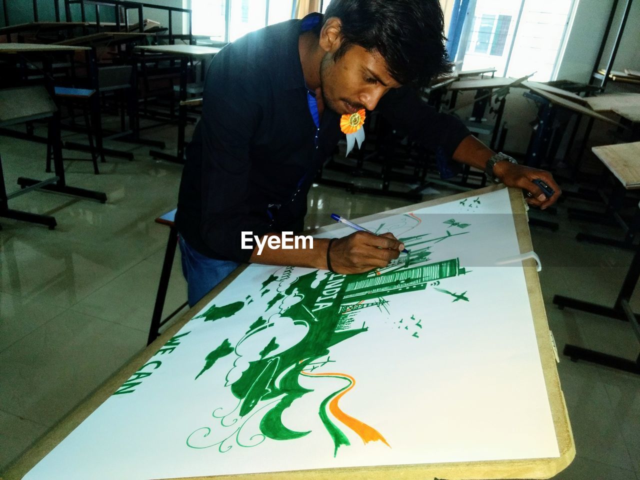 MIDSECTION OF MAN ON TABLE IN OFFICE