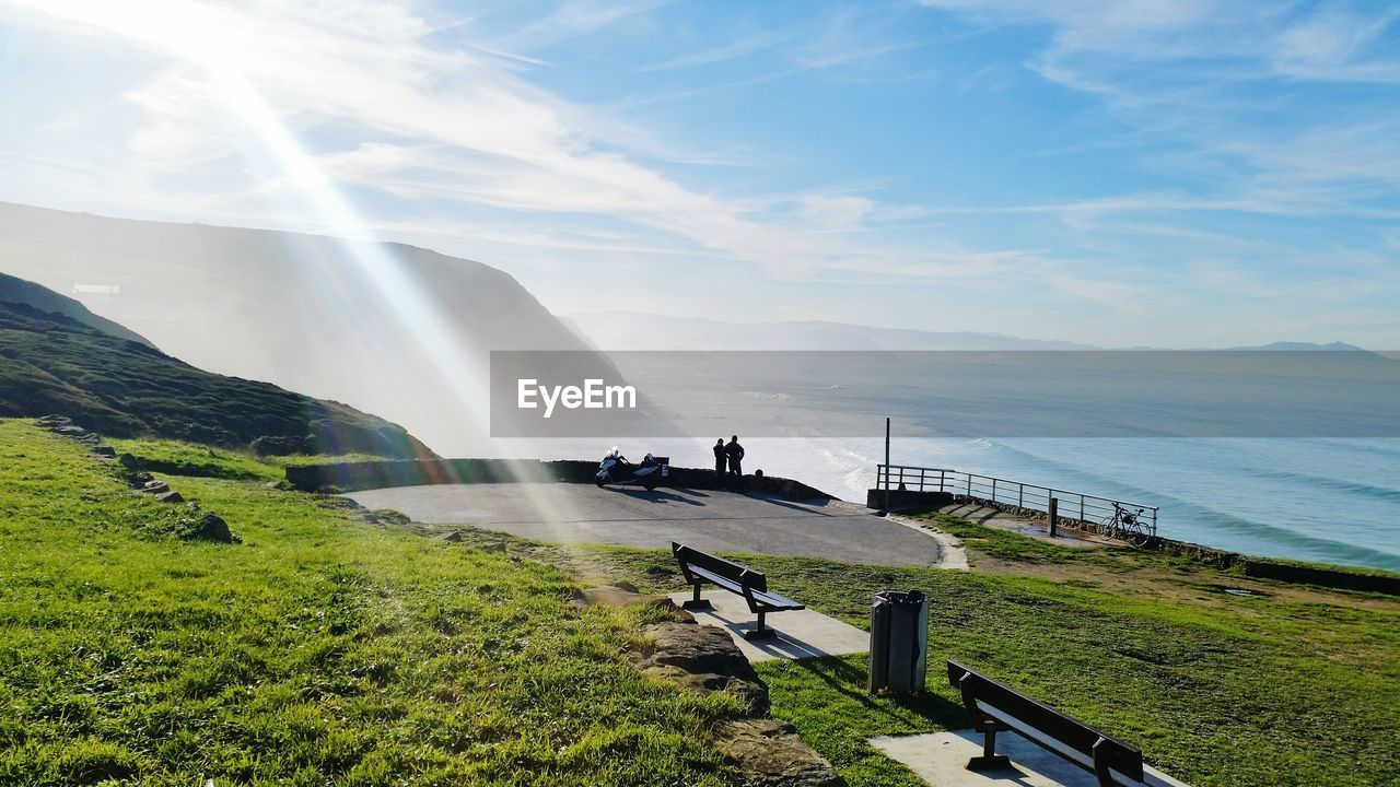 Scenic view of mountain and sea against sky