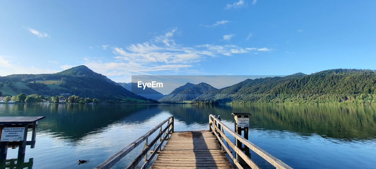 Pier over lake against sky