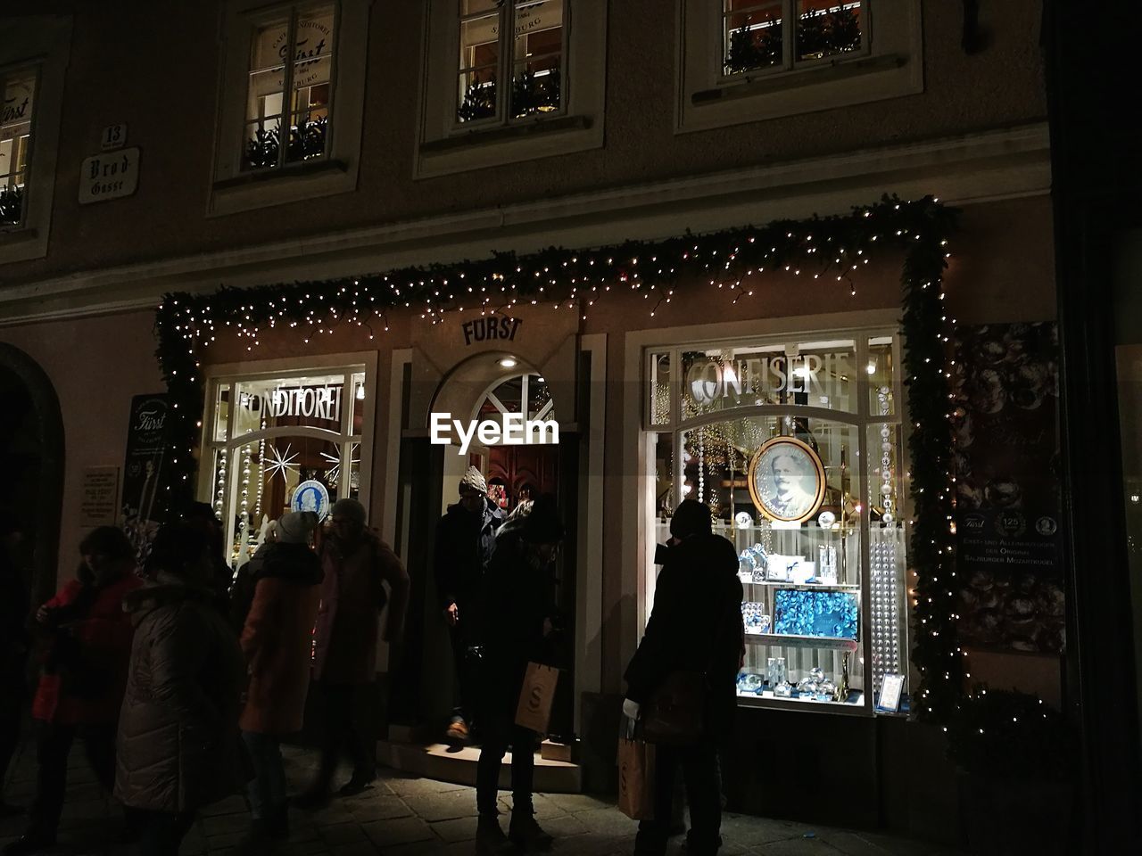 PEOPLE IN ILLUMINATED STORE