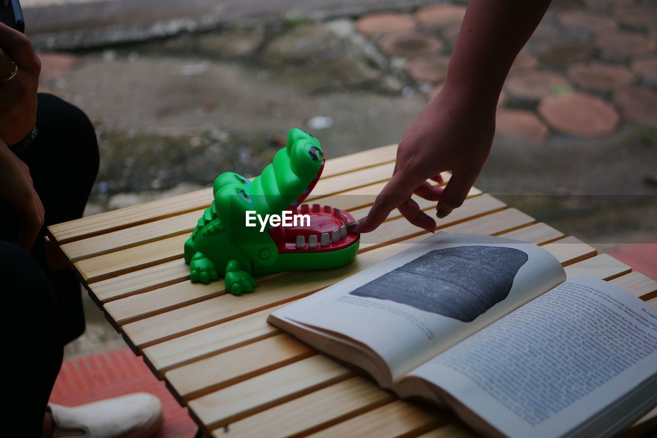 HIGH ANGLE VIEW OF WOMEN HOLDING BOOK