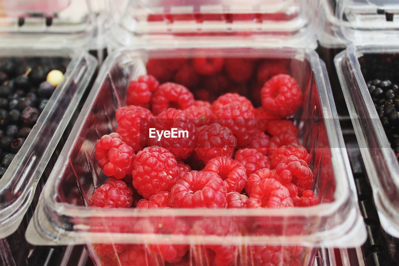 High angle view of raspberries in container for sale 