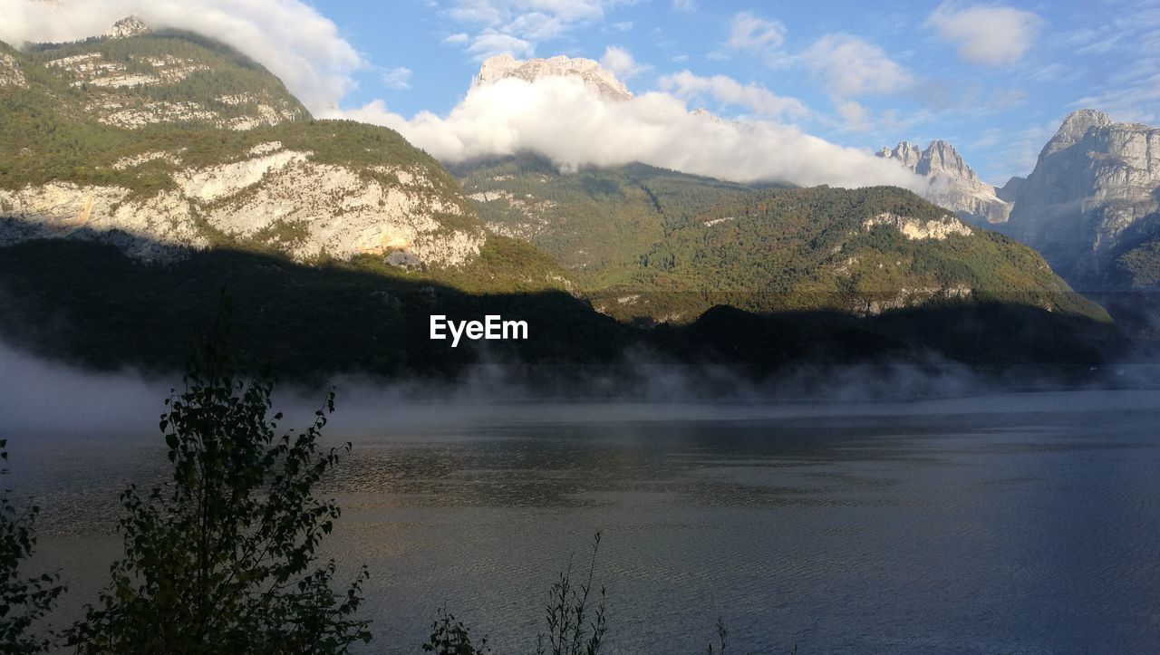 Scenic view of lake and mountains against sky