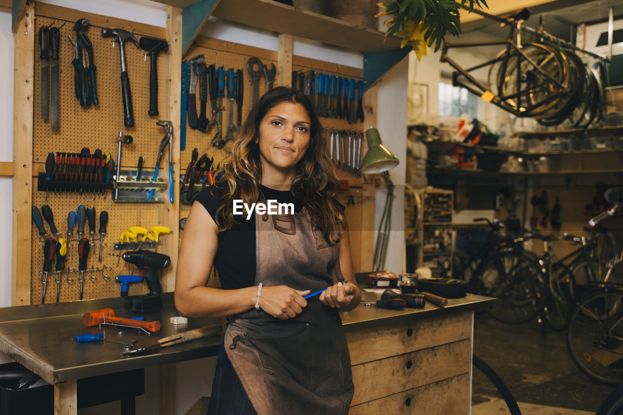 Female mechanic standing in repair shop