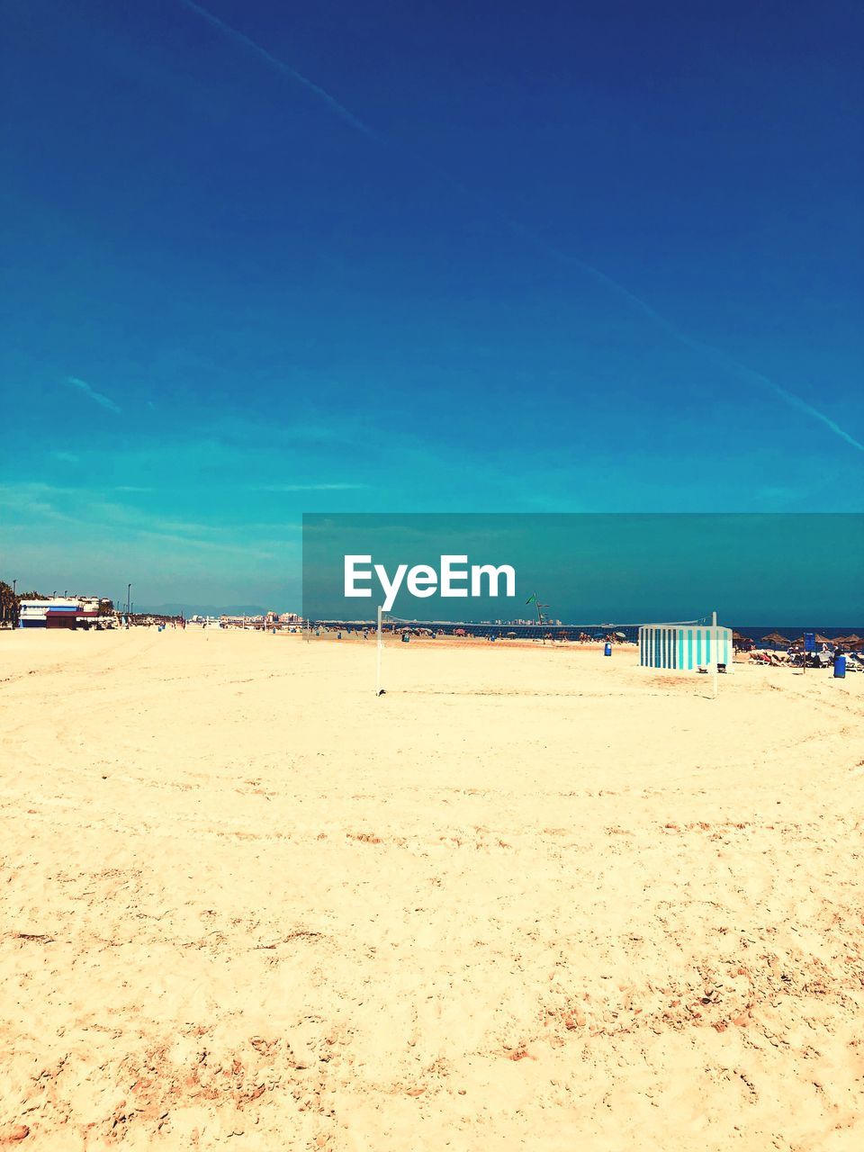 Scenic view of beach against blue sky