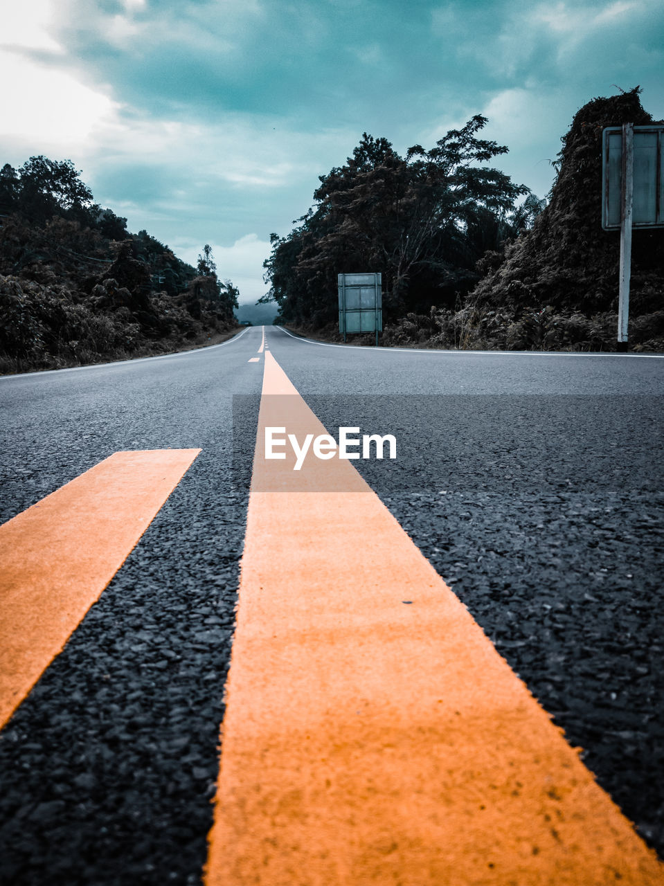 SURFACE LEVEL OF ROAD AGAINST CLOUDY SKY
