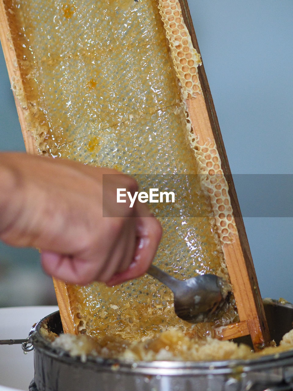 one person, hand, food and drink, food, holding, adult, indoors, baked, yellow, close-up, pouring, freshness, occupation, dish