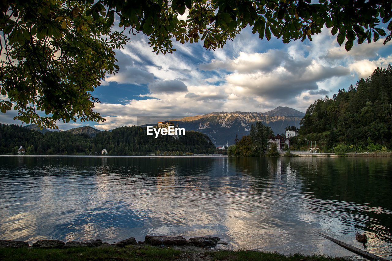 Scenic view of lake bled cloudy sky