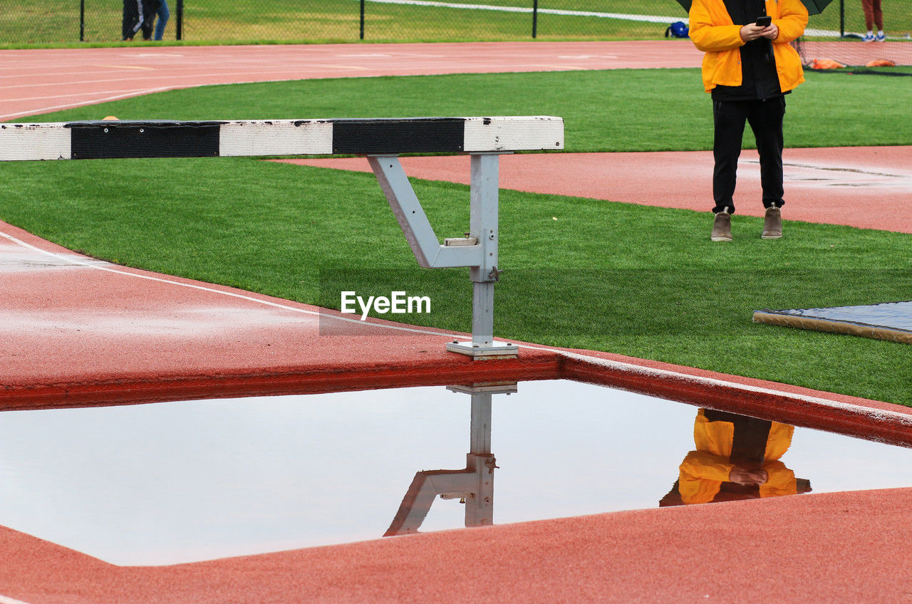 sports, baseball field, sport venue, track and field event, standing, men, grass, playground, adult, one person, competition, hurdle, day, stadium, athlete, clothing, nature, full length, outdoors, lifestyles, green, leisure activity