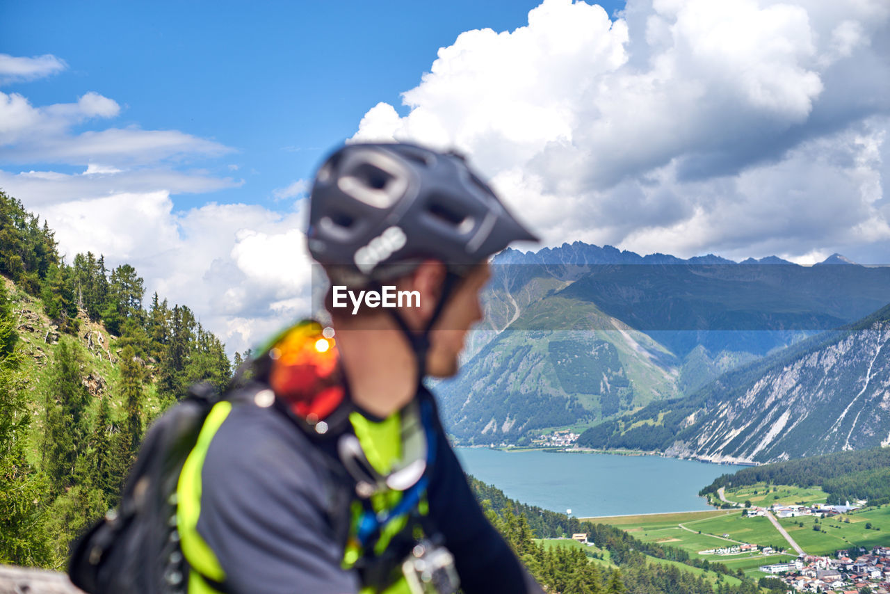 Man looking at lake and mountains