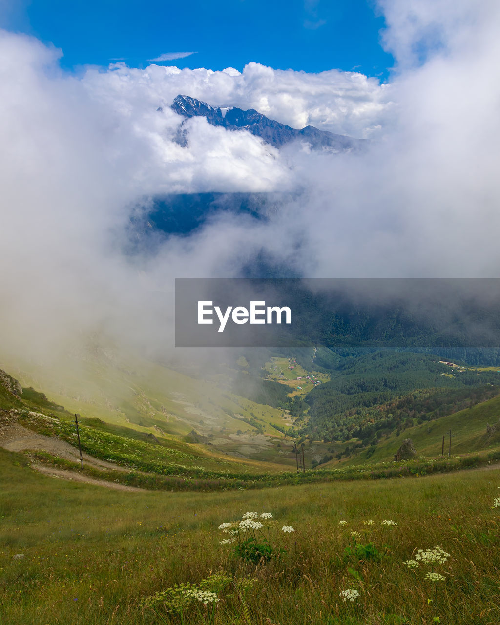 Landscape of the caucasus mountains, clouds descend from the peaks.