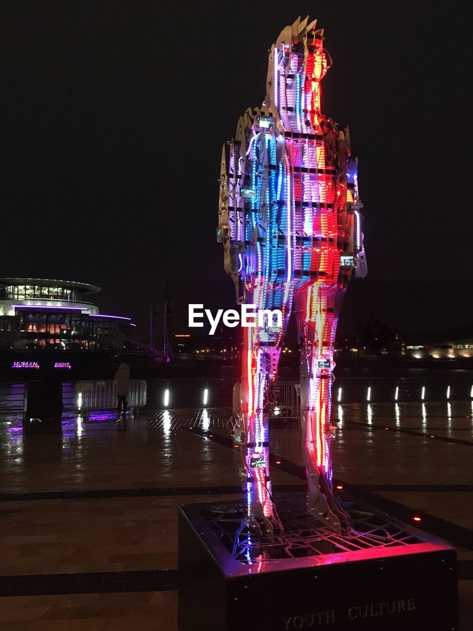 ILLUMINATED CITY BUILDINGS AT NIGHT