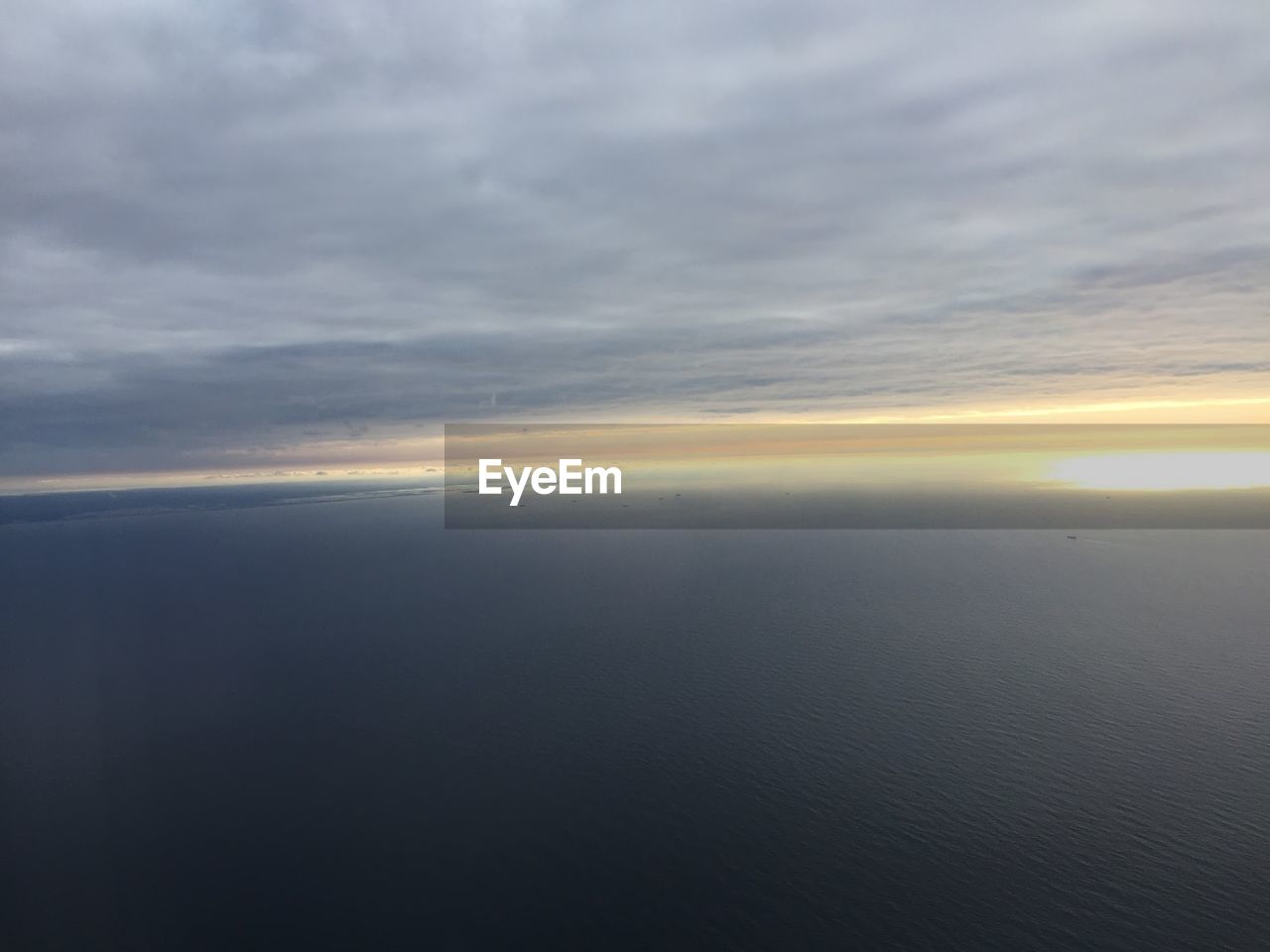 High angle view of sea over cloudy sky
