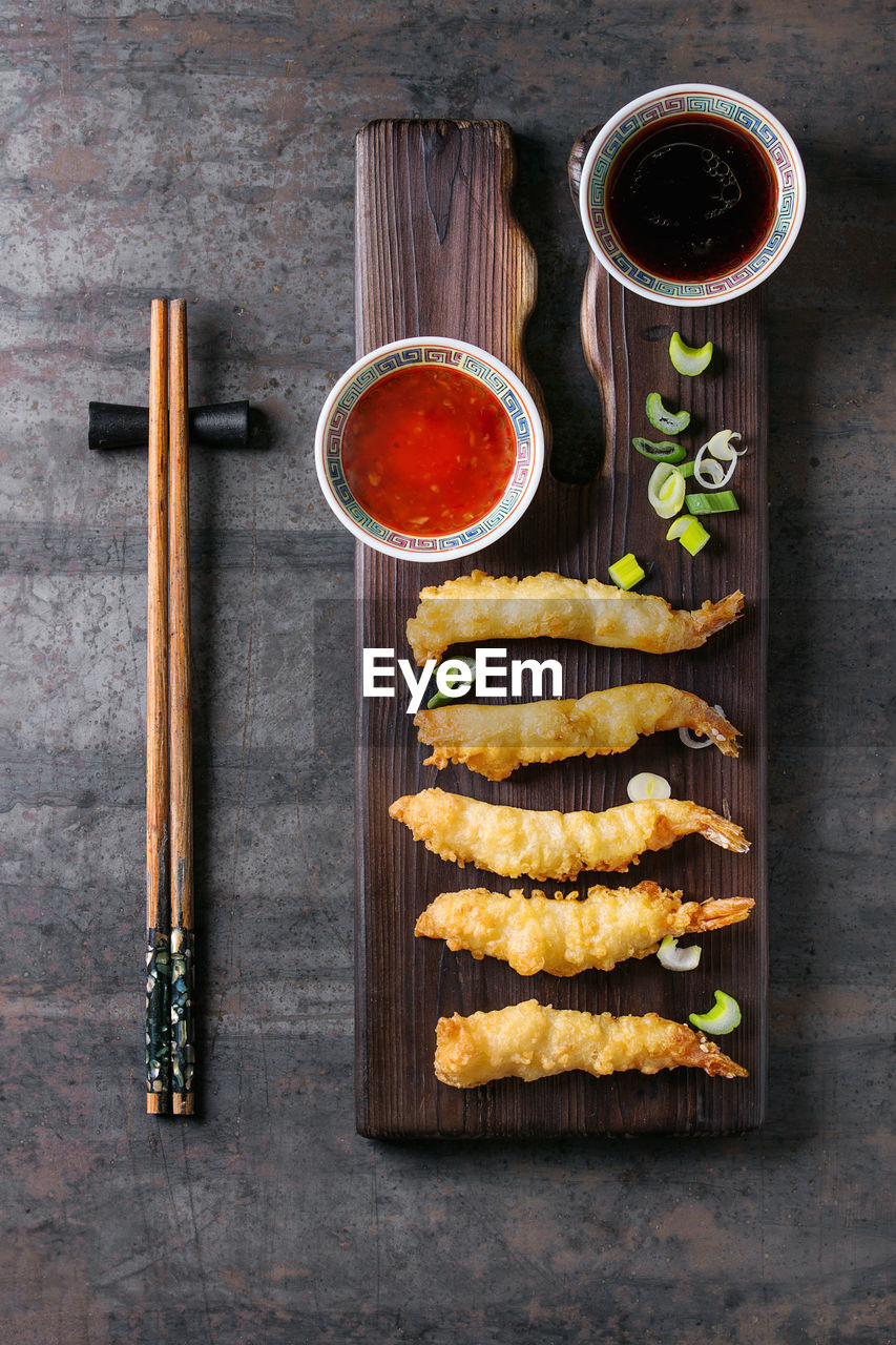 HIGH ANGLE VIEW OF VARIOUS FOOD ON TABLE AGAINST WALL