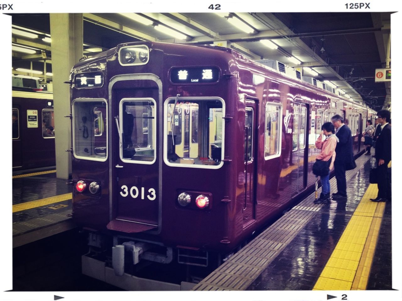 TRAIN ON RAILROAD STATION PLATFORM