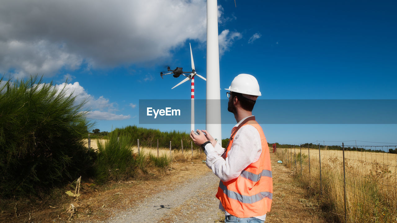 Engineer is using a drone in a wind field