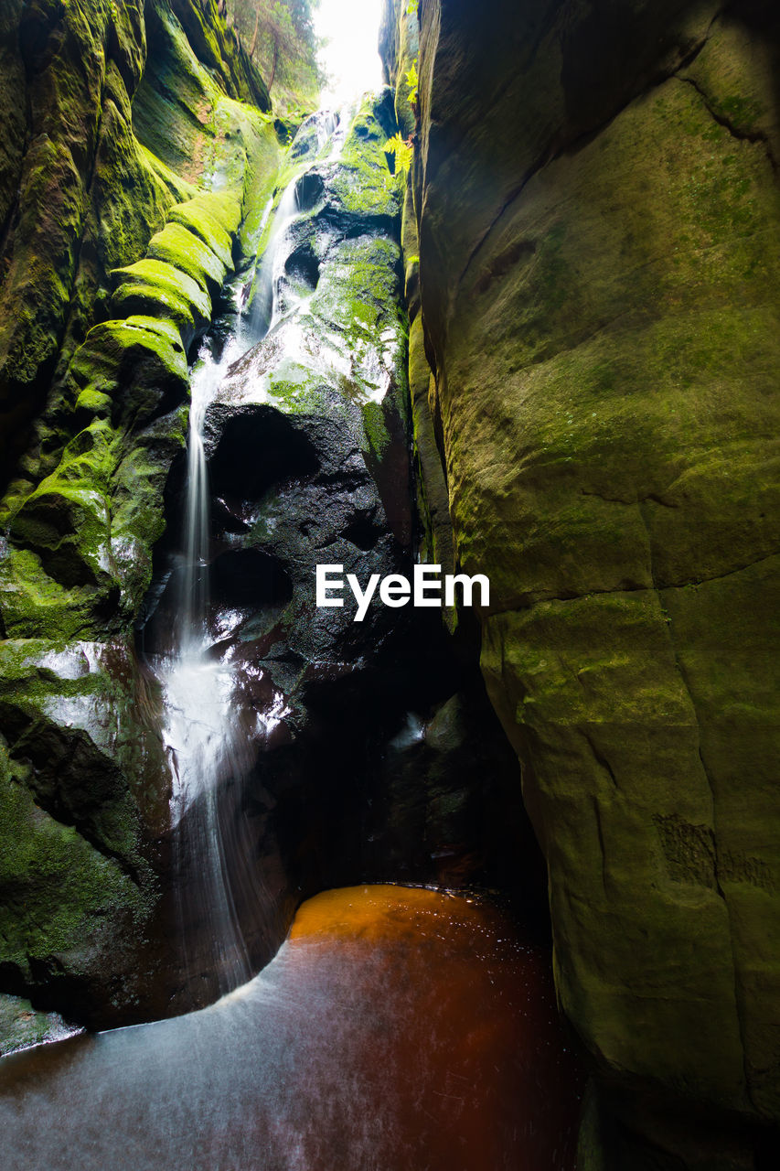 VIEW OF WATERFALL ALONG ROCKS