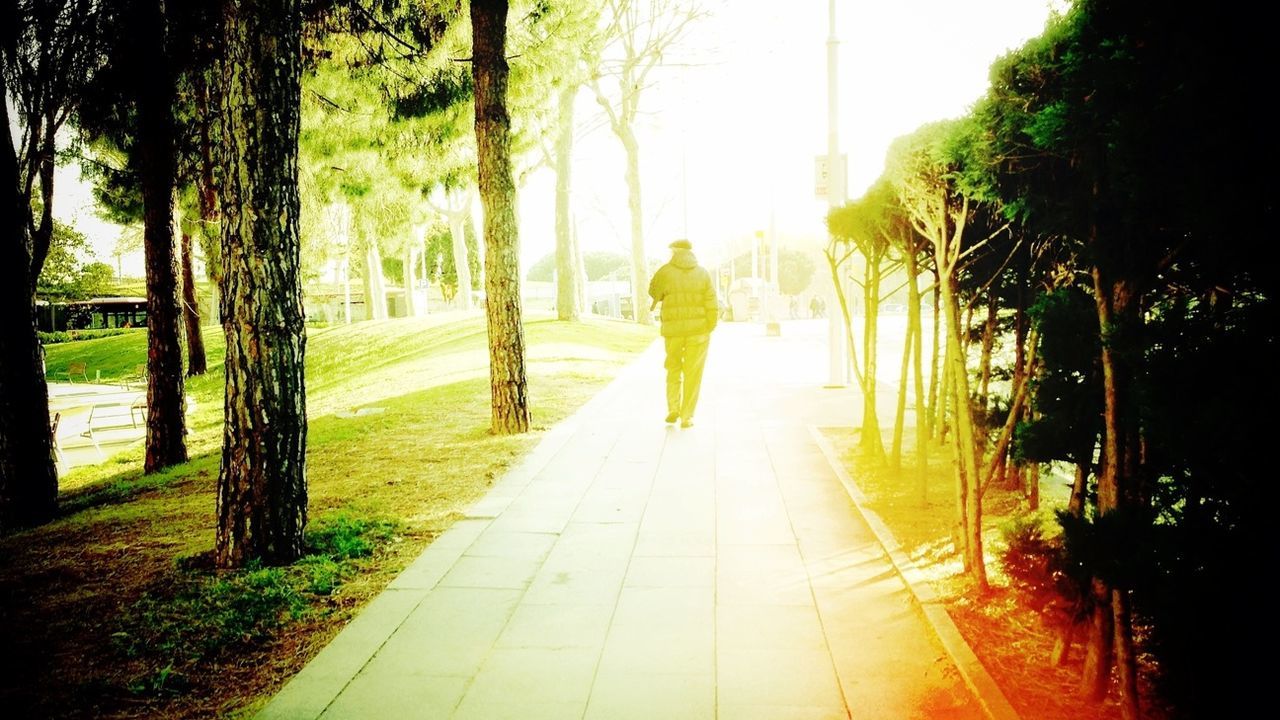 WOMAN WALKING ON FOOTPATH