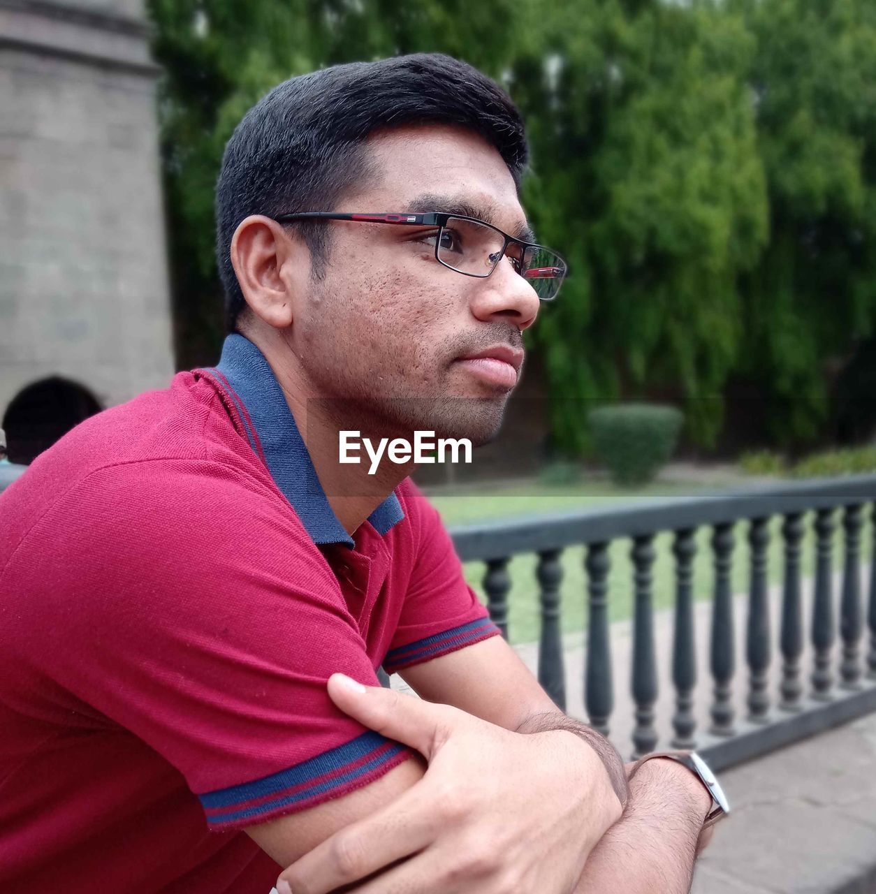 Side view of thoughtful young man looking away in park