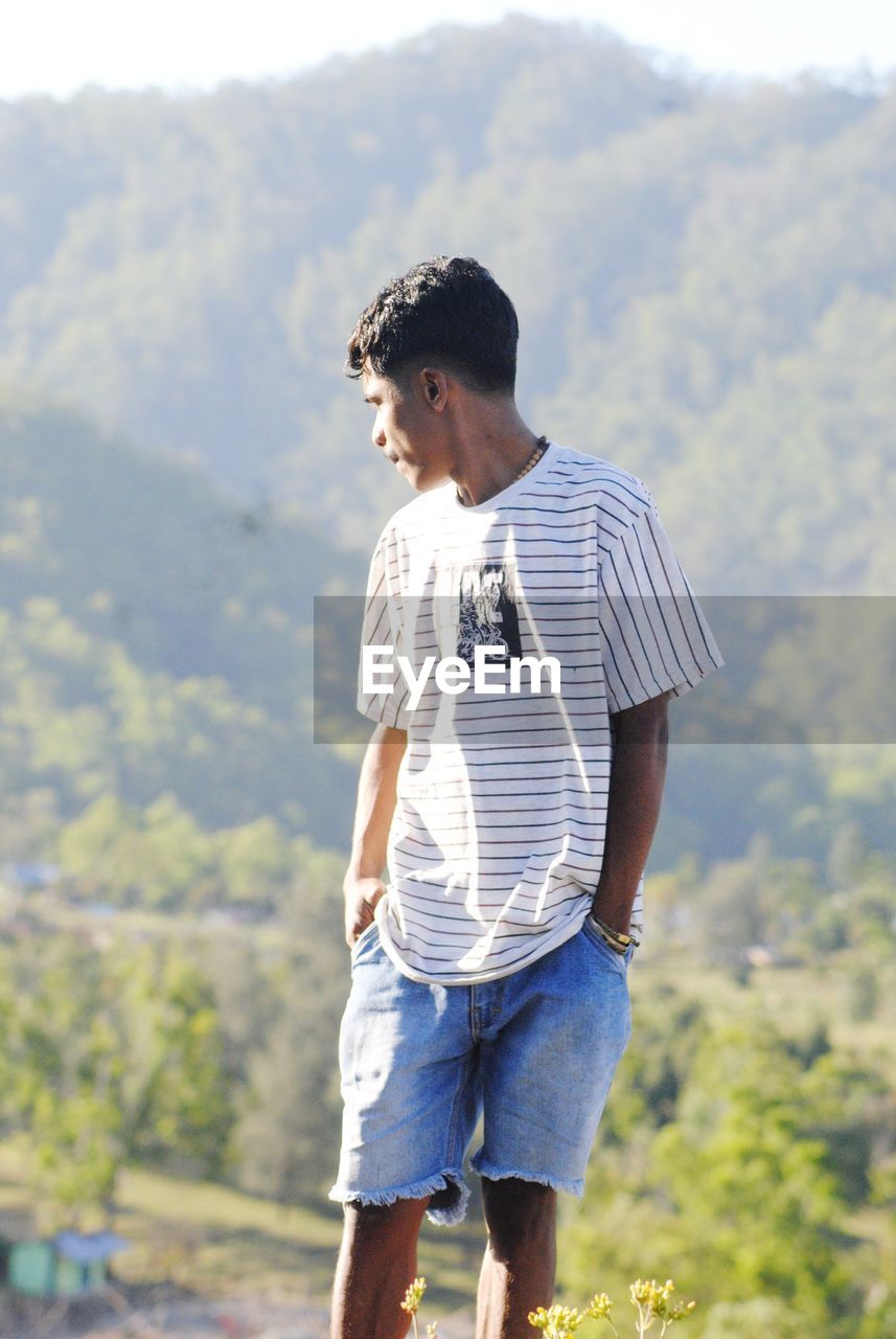 Full length of young man standing on field