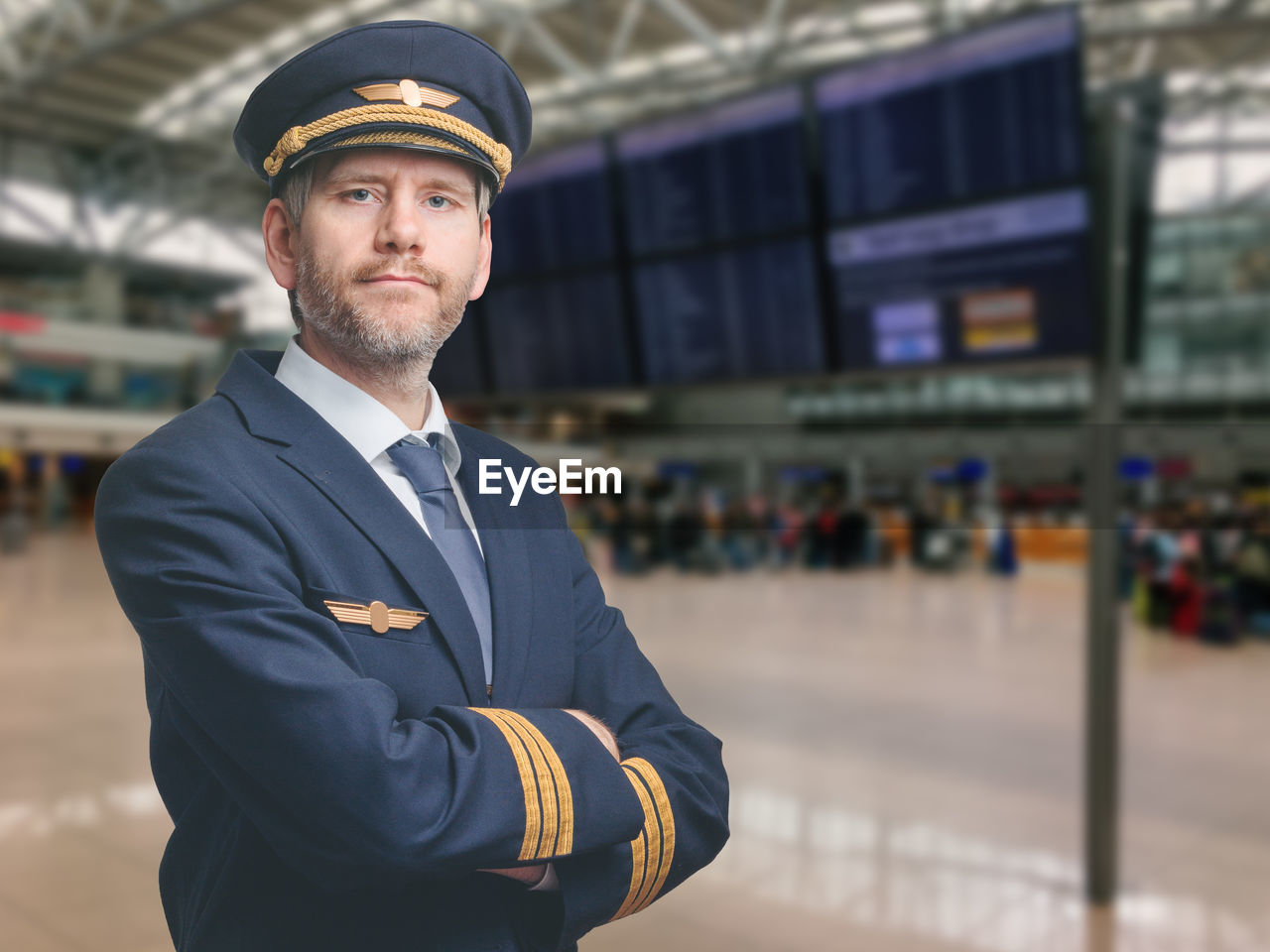Portrait of pilot standing at airport