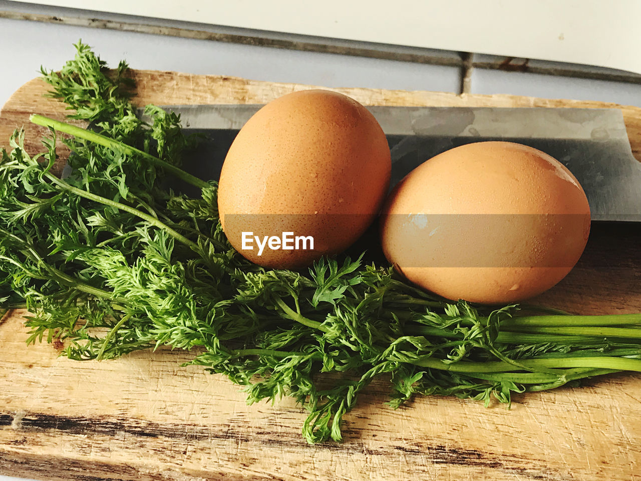 HIGH ANGLE VIEW OF EGGS IN CONTAINER ON TABLE