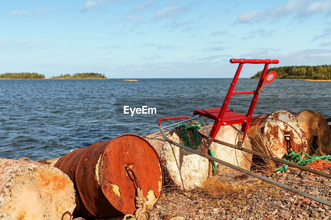 Someone has left a traditional red kicksled by the old barrels at the fishing harbour. 