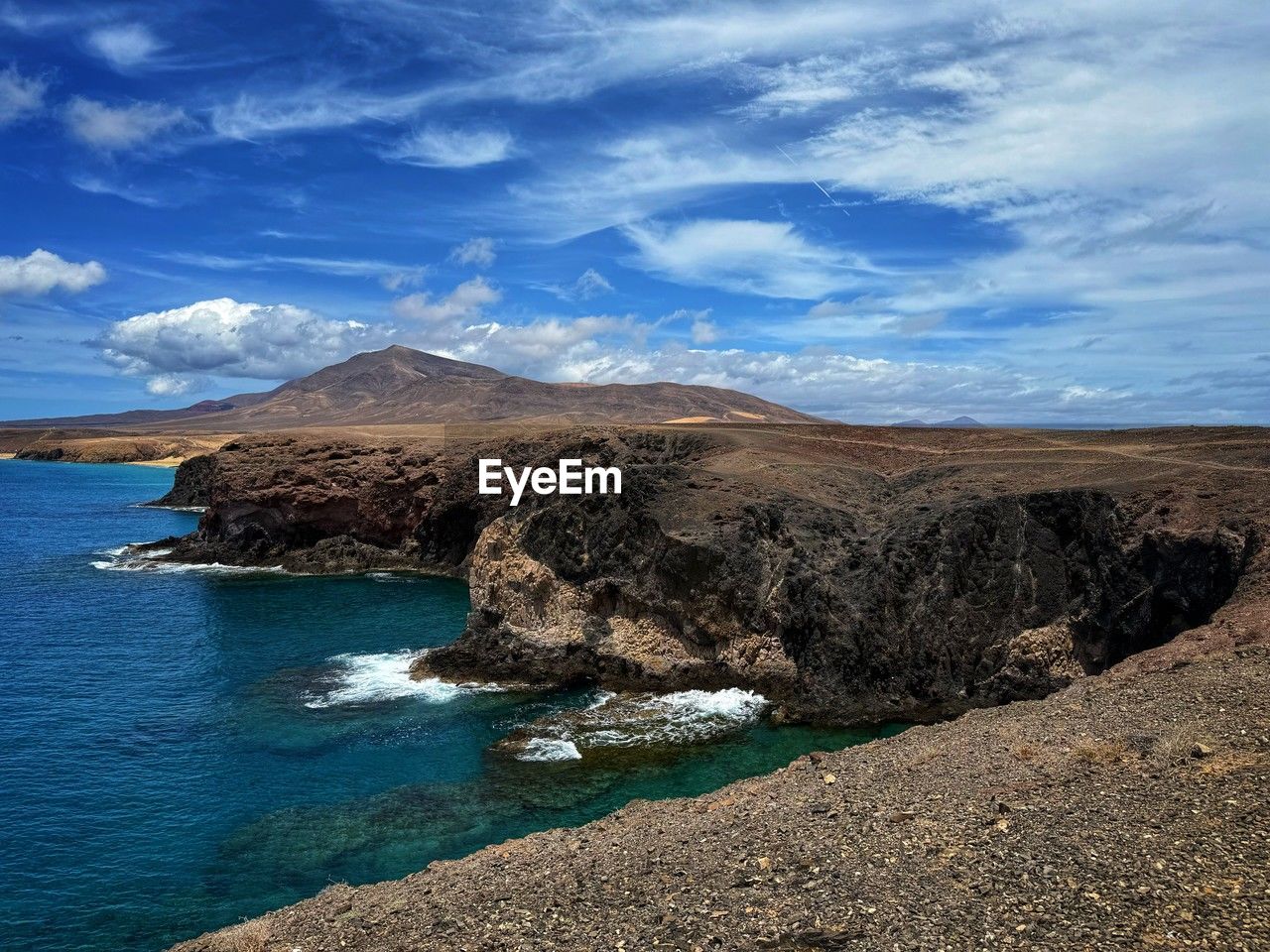 water, sea, scenics - nature, sky, land, beauty in nature, cloud, coast, environment, landscape, ocean, nature, shore, mountain, beach, rock, horizon, travel destinations, tranquility, no people, body of water, tranquil scene, blue, travel, non-urban scene, bay, outdoors, day, coastline, cliff, terrain, tourism, volcano, idyllic, island, cove, geology
