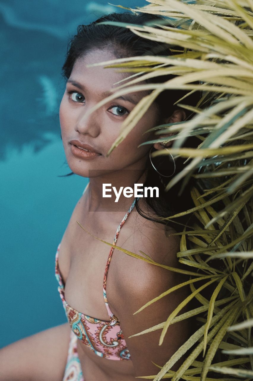 Portrait of young woman swimming in pool