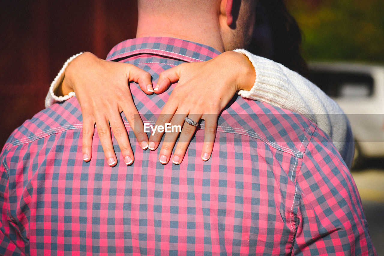 Midsection of couple standing outdoors