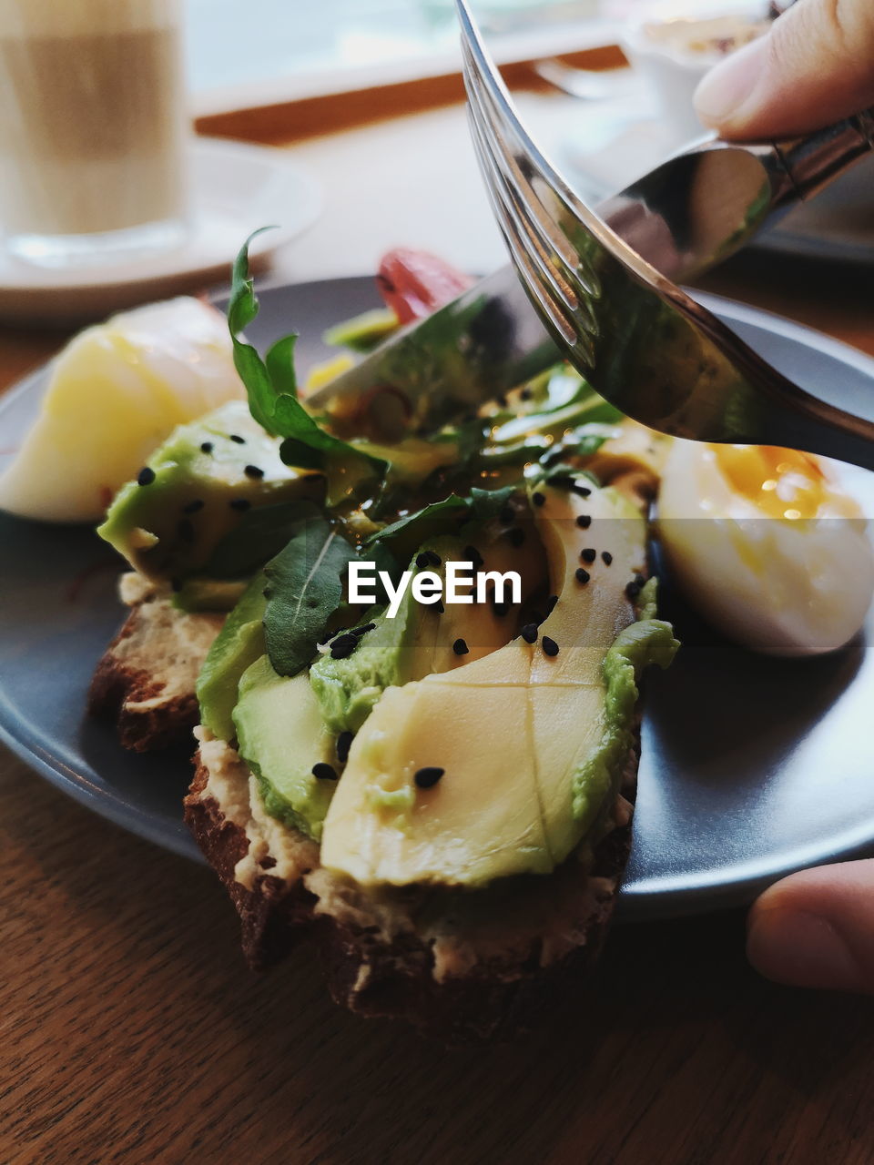 Close-up of hand holding food on table