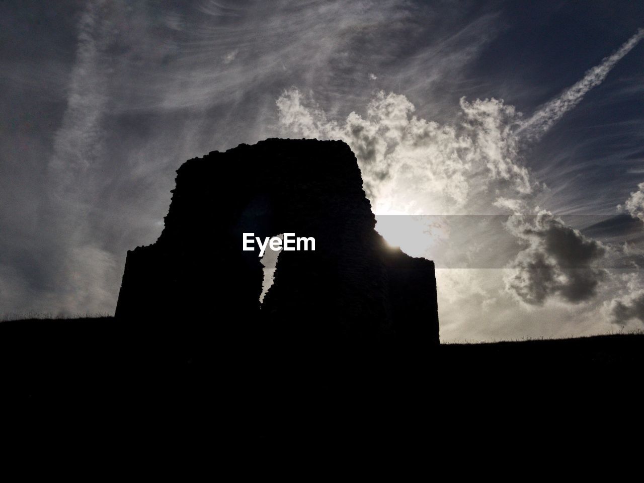 LOW ANGLE VIEW OF SILHOUETTE BUILT STRUCTURES AGAINST THE SKY